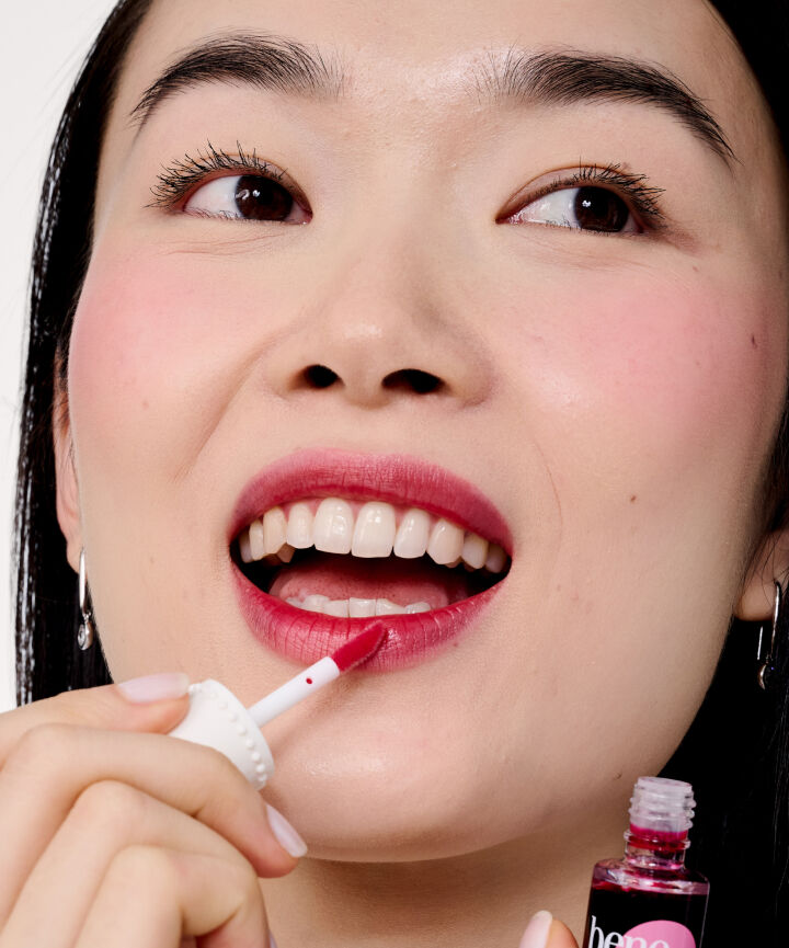 Close up of Model's face, applying lip tint