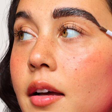 Close up of Model's face, applying brow makeup