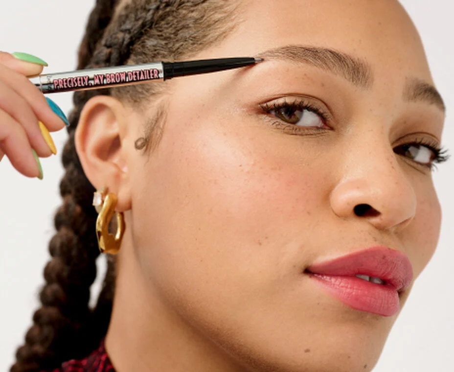 Model using eyebrow pencil