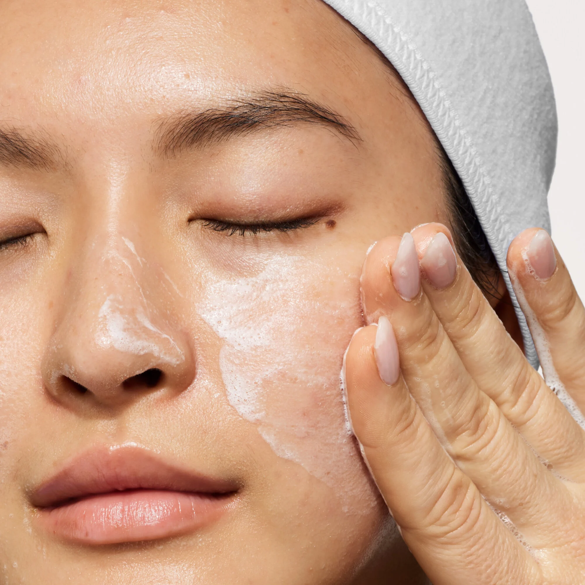 Model with cleansing soap on face